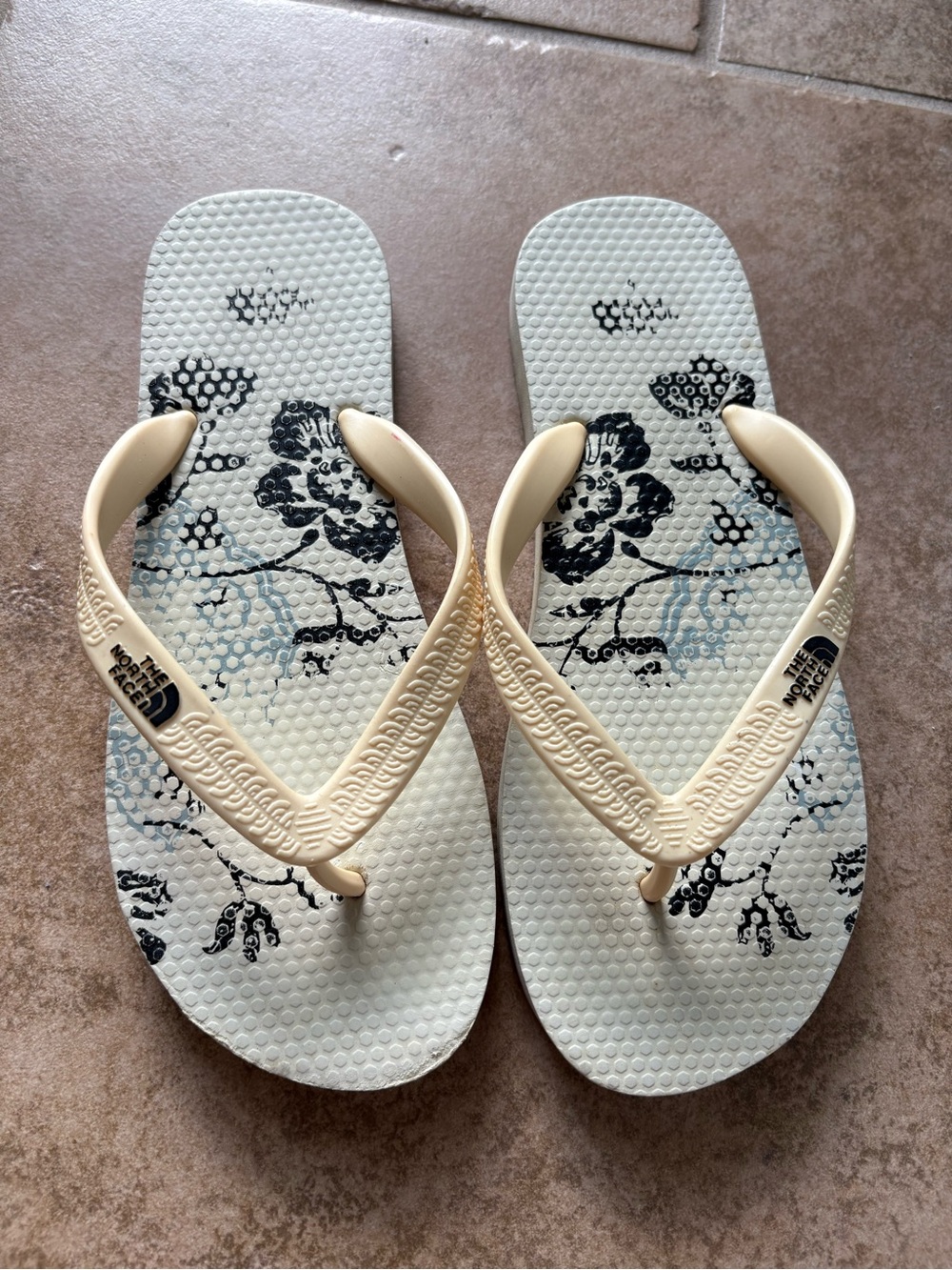 The North Face Women's Cream Flip Flop Sandals with Black Floral Print